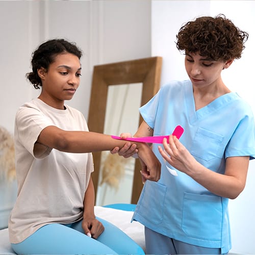 Study Bachelor of Occupational Therapy degree graduate assisting a patient with arm rehabilitation exercises