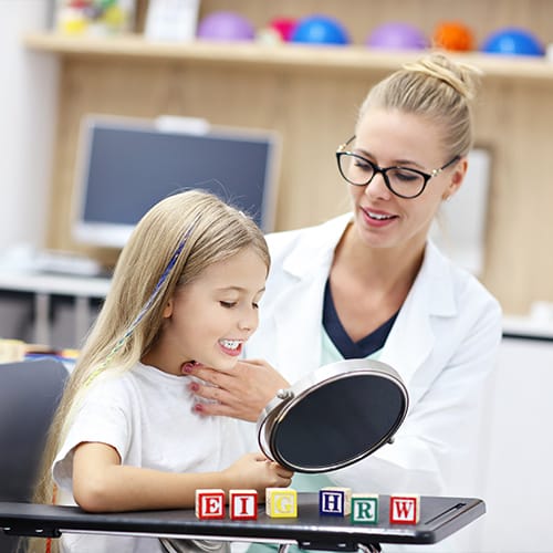 Bachelor of Speech Pathology students helping a child