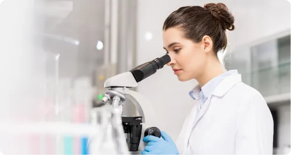 MSc forensic student working with a micro scope in lab